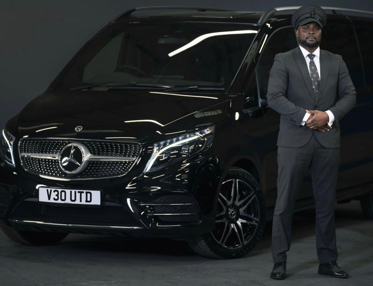 MDS Arabama chauffeur beside a black Mercedes V-Class
